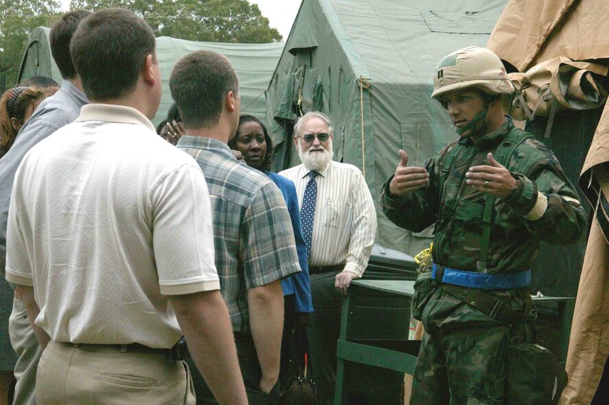 SHAW AIR FORCE BASE, S.C. -- Capt. Travis Guidt, 20th Civil Engineer Squadron, explains the role of the civil engineer cantonment area to 24 members of Leadership Sumter during a Phase II operational readiness exercise May 9. Leadership Sumter is a 10-month leadership class sponsored by the Sumter Chamber of Commence for top management in business, industry, government and education. The group visited the field hospital, chaplains and the civil engineer cantonment area and observed a base intrusion and security forces response exercise. (U.S. Air Force photo/Senior Airman John Gordinier)
