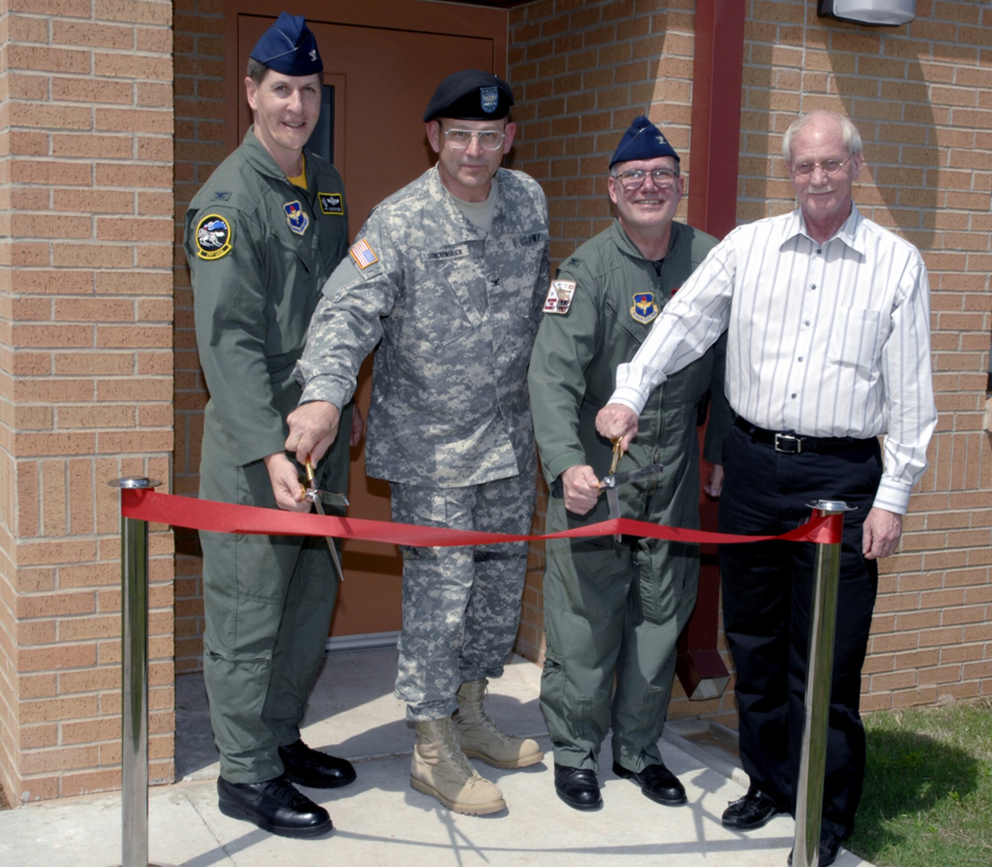 Col. Richard Klumpp, Jr., 71st Flying Training Wing commander, Col. David Schuckenbrock,   Great Plains Regional Veterinarian Command commander, Col. John McCafferty, 71st Medical Group commander and Pat Renshaw, construction project manager, prepare to cut the ribbon to officially open Vance Air Force Base's new veterinary clinic during a ceremony May 4. (U.S. Air Force photo by Terry Wasson)