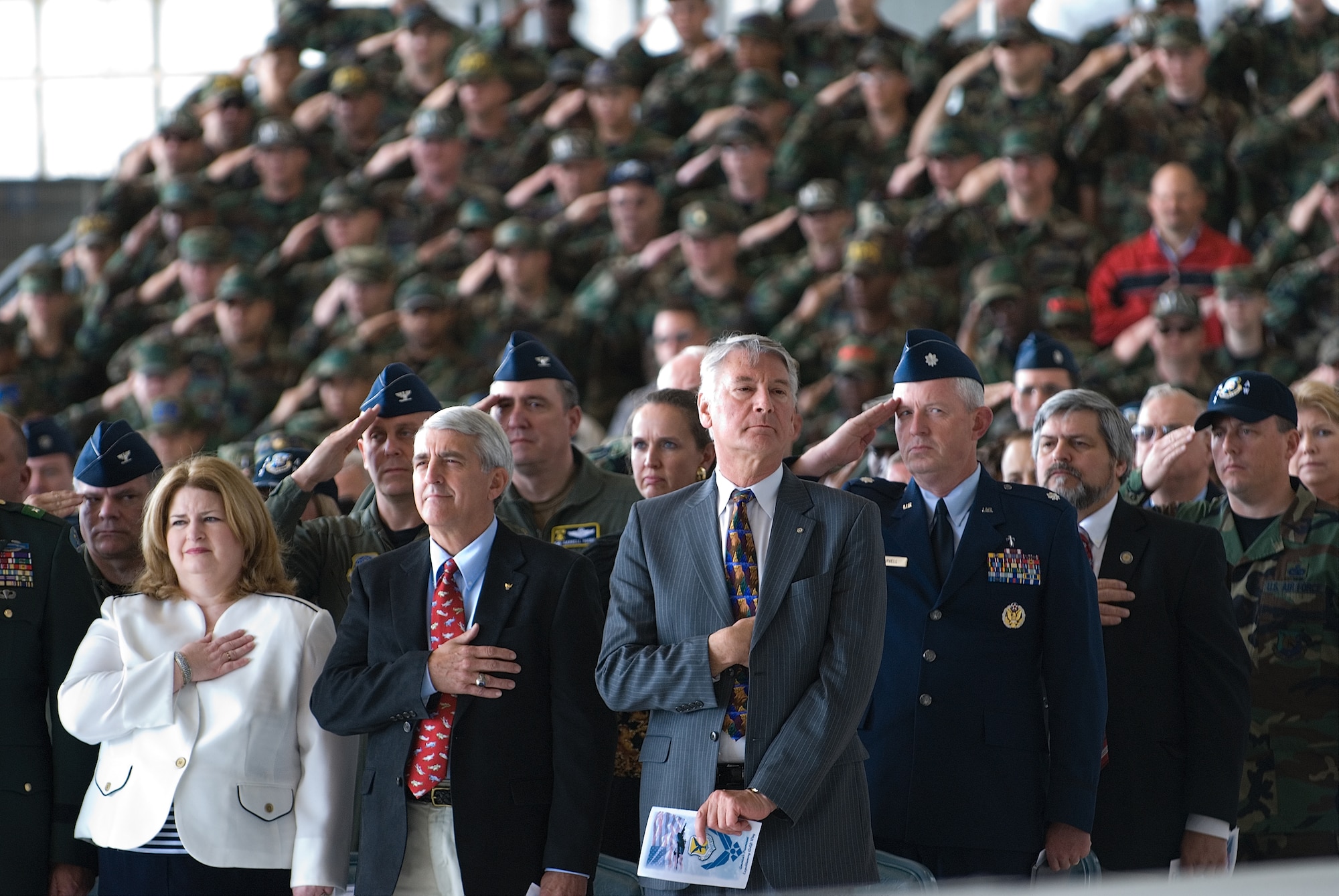 (Front row, left to right) Tanya Rutland, wife of Col. Ronald Rutland, 512th Airlift Wing commander, retired Col. Ron Love and Dan Wolfensboerger, Delaware Economic Developement Office, honor the American Flag during the National Anthem May 8. (U.S. Air Force photo/Roland Balik)