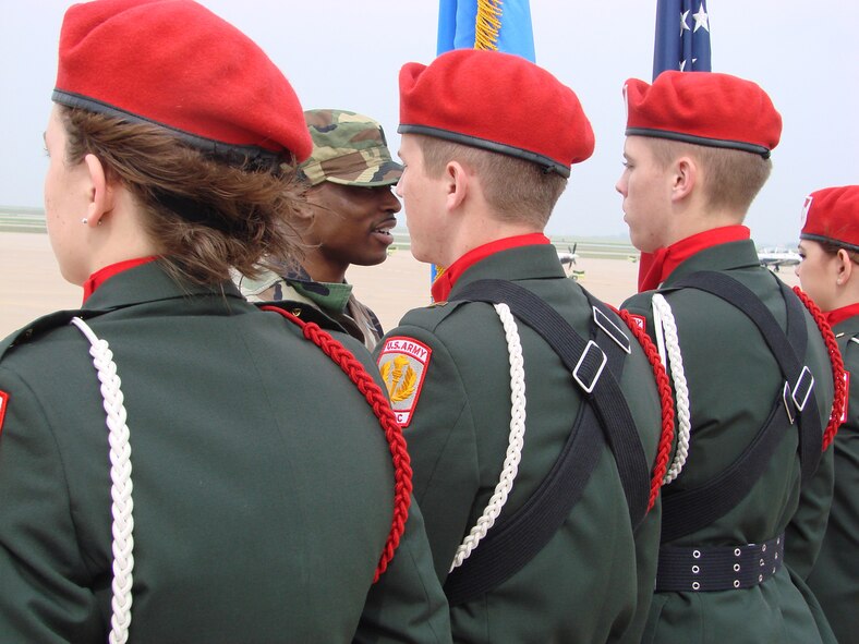 Senior Airman Trae Clark, 32nd Flying Training Squadron, inspects the Mustang (Okla.) High School Army Junior ROTC honor guard during the Air Force 60th Anniversary Invitational Drill Meet at Vance Air Force Base Saturday. The Mustang team won the honor guard portion of the competition as well as taking the day's overall title. (U.S. Air Force photo by Frank McIntyre)     