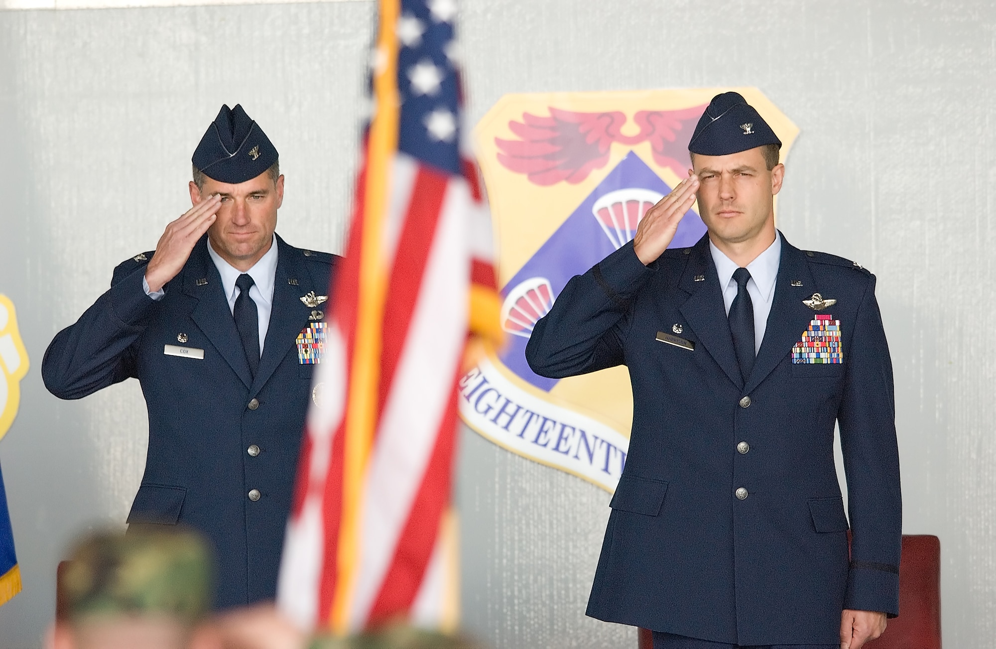 (Left to right) Col. Sam Cox and Col. Steven Harrison, 436th Airlift Wing commander, salute Old Glory during the National Anthem at the 436th AW Change-of-Command Ceremony May 8. Colonel Harrison assumed command of the Eagle Wing from Colonel Cox. (U.S. Air Force Photo/Jason Minto)