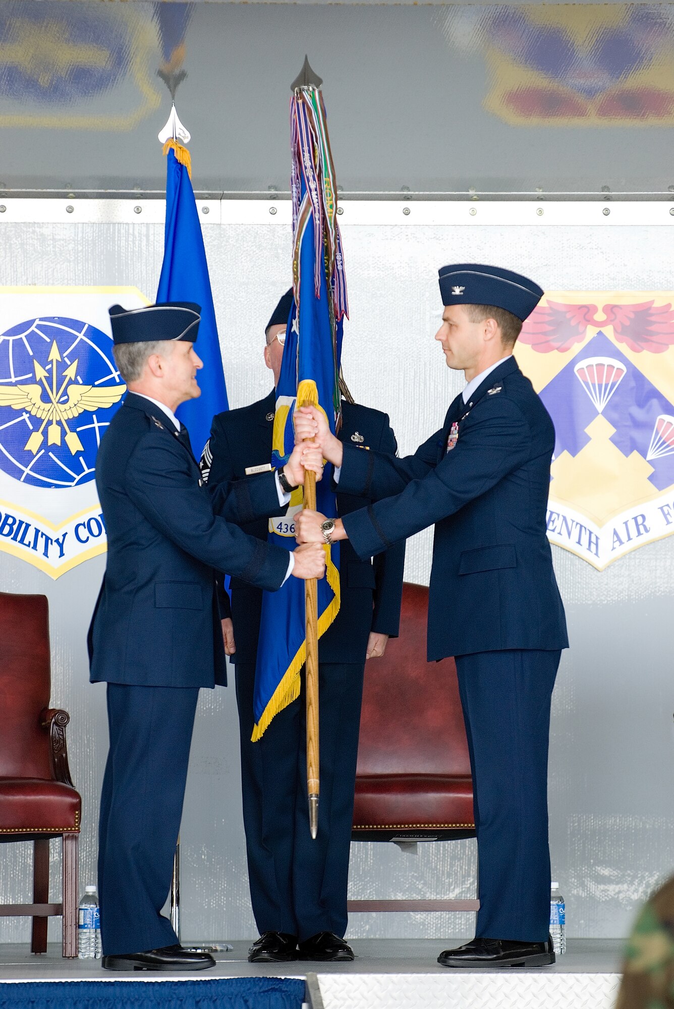 Col. Steven Harrison, 436th Wing commander, accepts the 436th AW guidon from Maj. Gen. James Hawkins, 18th Air Force commander, during a change-of-command ceremony May 8. Colonel Harrison assumed command from Col. Sam Cox, who will be filling a position at the Pentagon, Washington D.C. (U.S. Air Force Photo/Roland Balik)