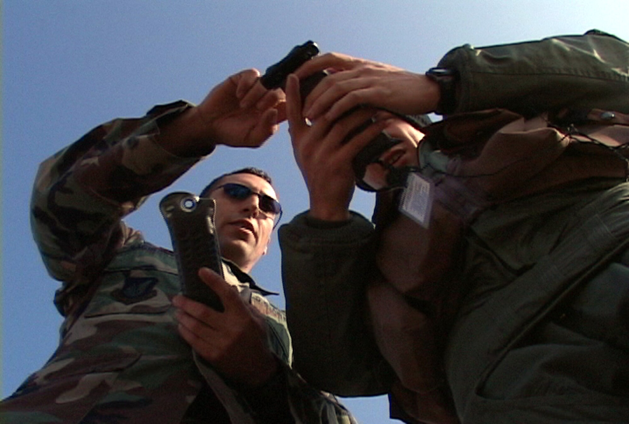 Staff Sgt. Anthony Raciborski gives pilot Capt. Matt Belle pointers on using his equipment before sending him into the woods May 5 for evasion training at Misawa Air Base, Japan. Sergeant Raciborski is a Survival, Evasion Resistance, Escape specialist, with the 35th Operations Support Squadron. Captain Bell is assigned to the 13th Fighter Squadron. (U.S. Air Force photo/Petty Officer 1st Class Hendrick Simoes)