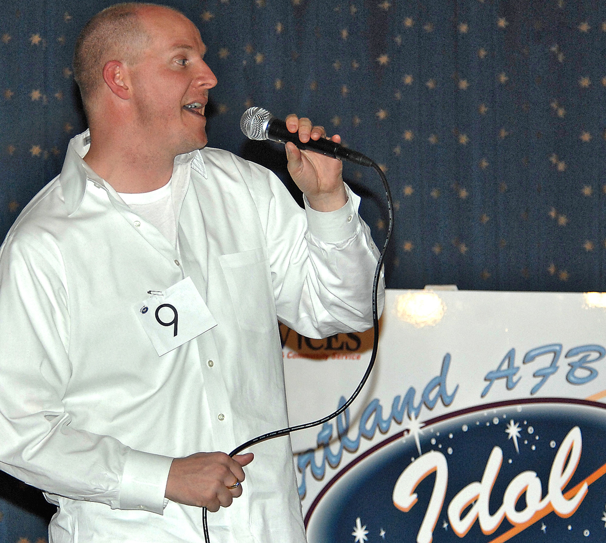 Kirtland Idol first place winner John Woodworth sings ?God Bless the U.S.A.? at the contest?s finals April 27. Mr. Woodworth brings home $700 and an opportunity to open Kirtland?s Summer Base July 20 at Hardin Field. U.S. Air Force photo by Adam Wooten