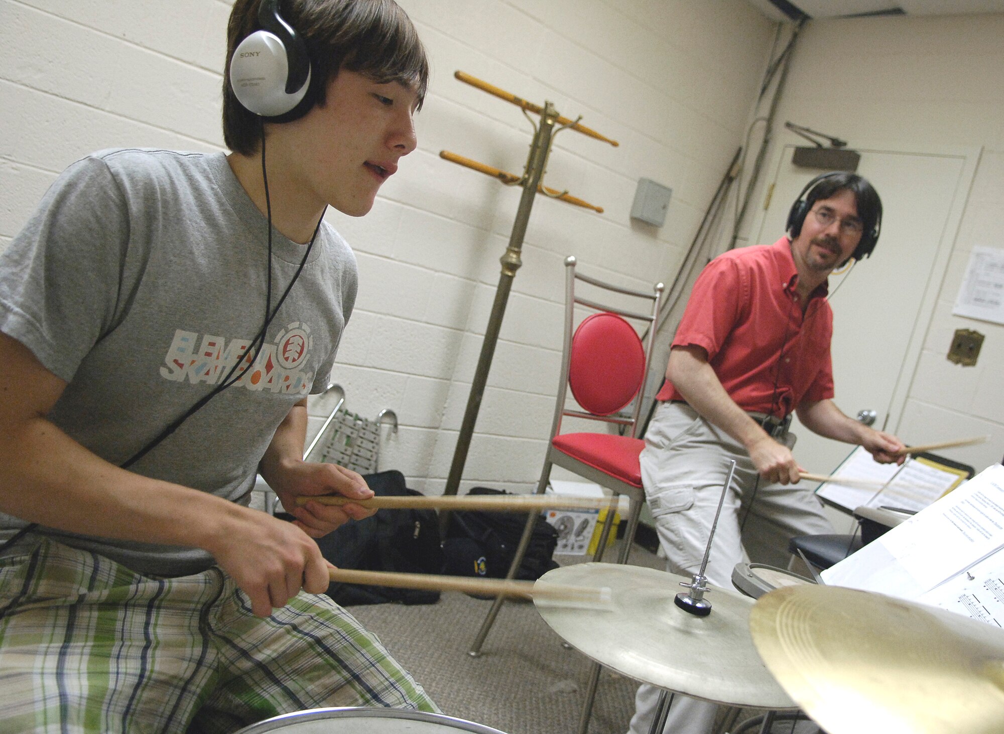Andrew Knepper plays the drums as his instructor, David Silverthorn, looks on. Mr. Silverthorn gives lessons at the Langley Community Center and is currently enrolling students. (U.S. Air Force photo/Senior Airman Austin Knox) 
