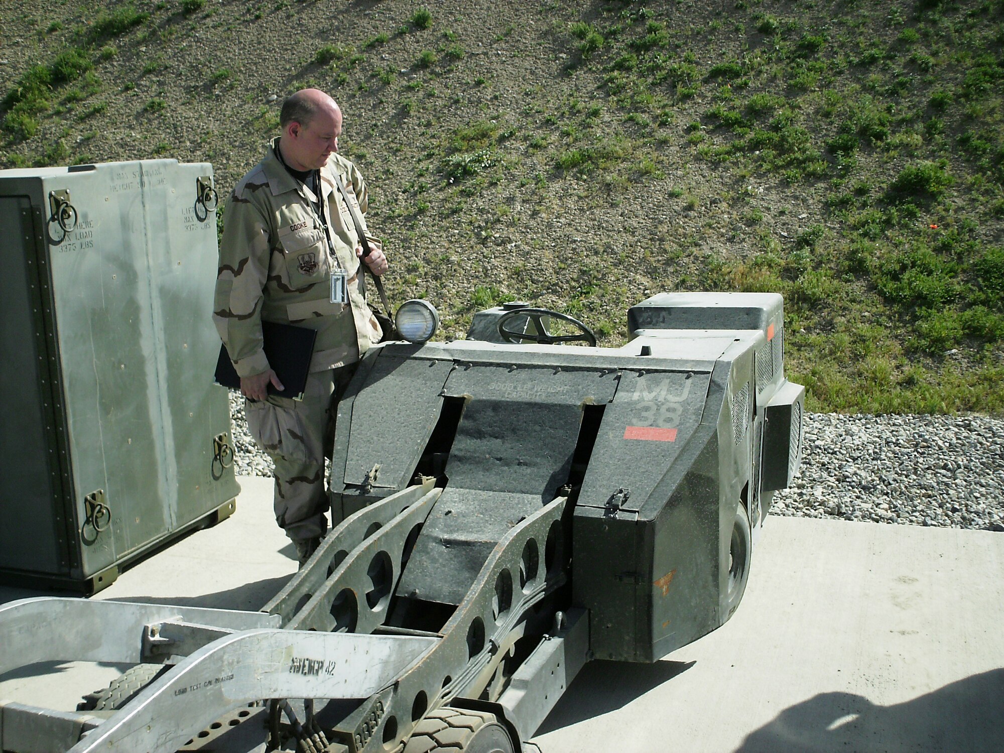Rob Cooke, corrosion team member, evaluates a munitions bomb lift for corrosion and weathering.