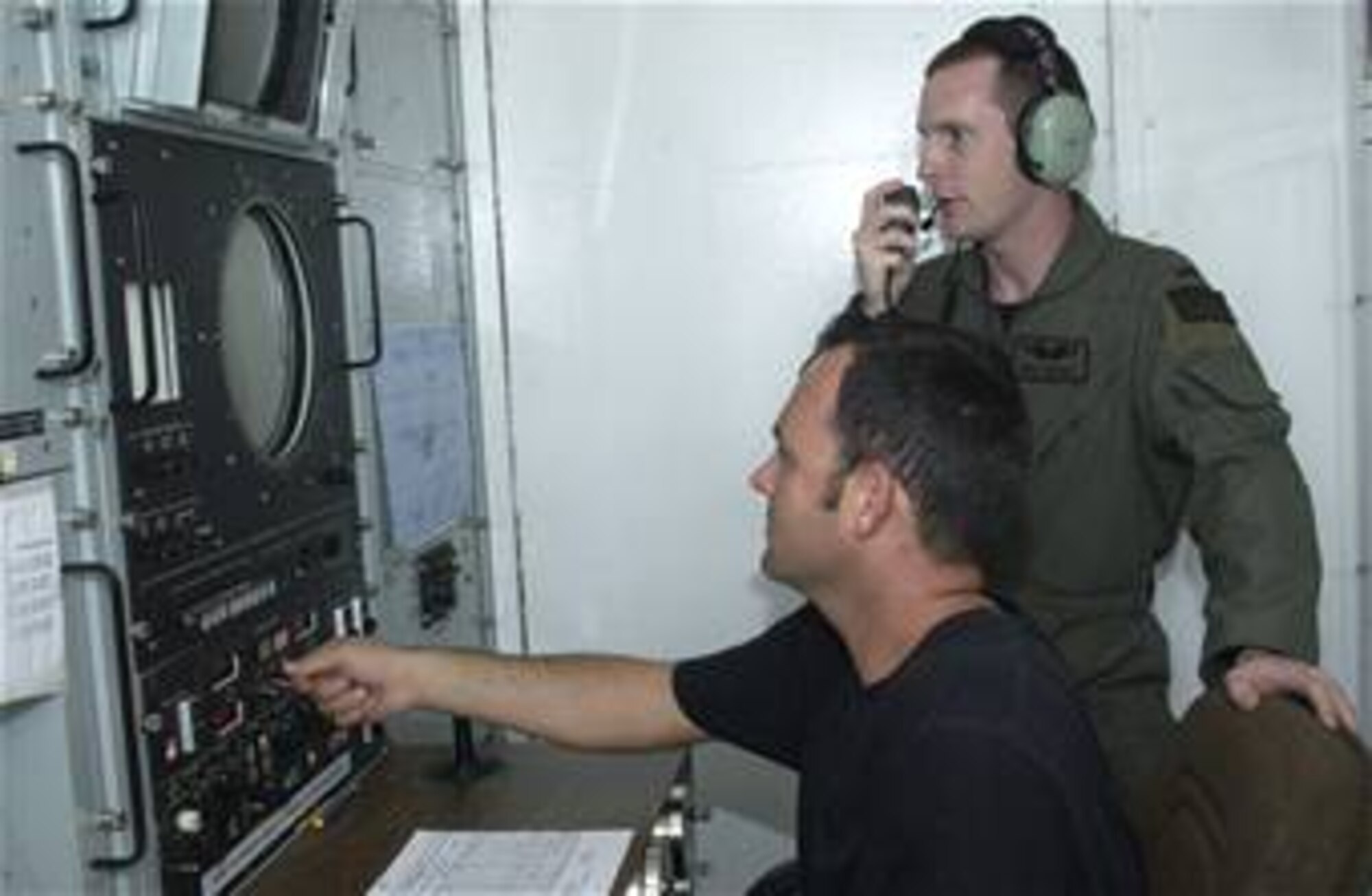 MOUNTAIN HOME AIR FORCE BASE, Idaho -- From left, Tech. Sgt. Donald Taylor, 266th Range Squadron ground radar technician, coordinates simulated threat signals with 1st Lt. Monty Moncrief, 23rd Expeditionary Bomb Squadron electronic warfare officer. The Multiple Threat Emitter System shapes radio wave pulses to look like signals radiated by aircraft threats, including surface-to-air missiles. Air Force photo by Staff Sgt. Eric Petosky