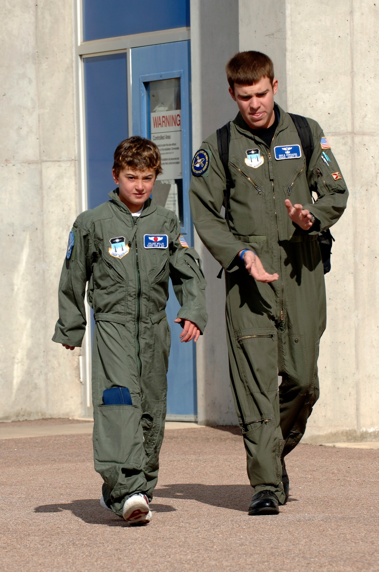 Ten-year-old Julian Willis walks with sophomore cadet Erik Gonsalves after taking a tour of the glider hangar at the U.S. Air Force Academy, Colo. The Make-a-Wish Foundation and the Air Force Academy made Julian a "Cadet for a Day". Cadets have sponsored 22 children since the program started in 2000. (U.S. Air Force photo/Mike Kaplan)