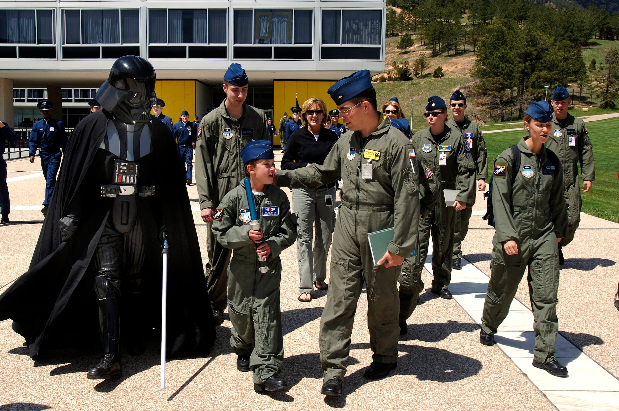 Ten-year-old Julian Willis is escorted by the Darth Vader character and cadets of squadron 39 to the lunchtime formation at the U.S. Air Force Academy, Colo. The Make-a-Wish Foundation and the Air Force Academy made Julian a "Cadet for a Day". Cadets have sponsored 22 children since the program started in 2000. (U.S. Air Force photo/Mike Kaplan)