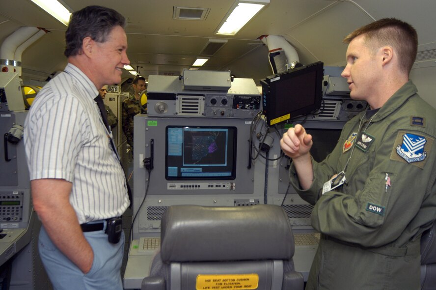 Capt. Joseph Steiner, right, 12th ACCS sensor management officer, explains his job to Curtis Thomas, Three Angels Seventh Day Adventist Church, during a tour for clergy of the JStars. U. S. Air Force photo by Sue Sapp   
