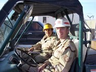 KANDAHAR AIRFIELD, AFGHANISTAN – Chaplain (Lt. Col.) Cassandra Thomas, base chaplain, and Tech. Sgt. James Hayes, chaplain’s assistant, set out in a work gator here as part of their field ministry. Both Airmen are currently deployed here from Minot Air Force Base in support of Operation Enduring Freedom. (Courtesy photo)