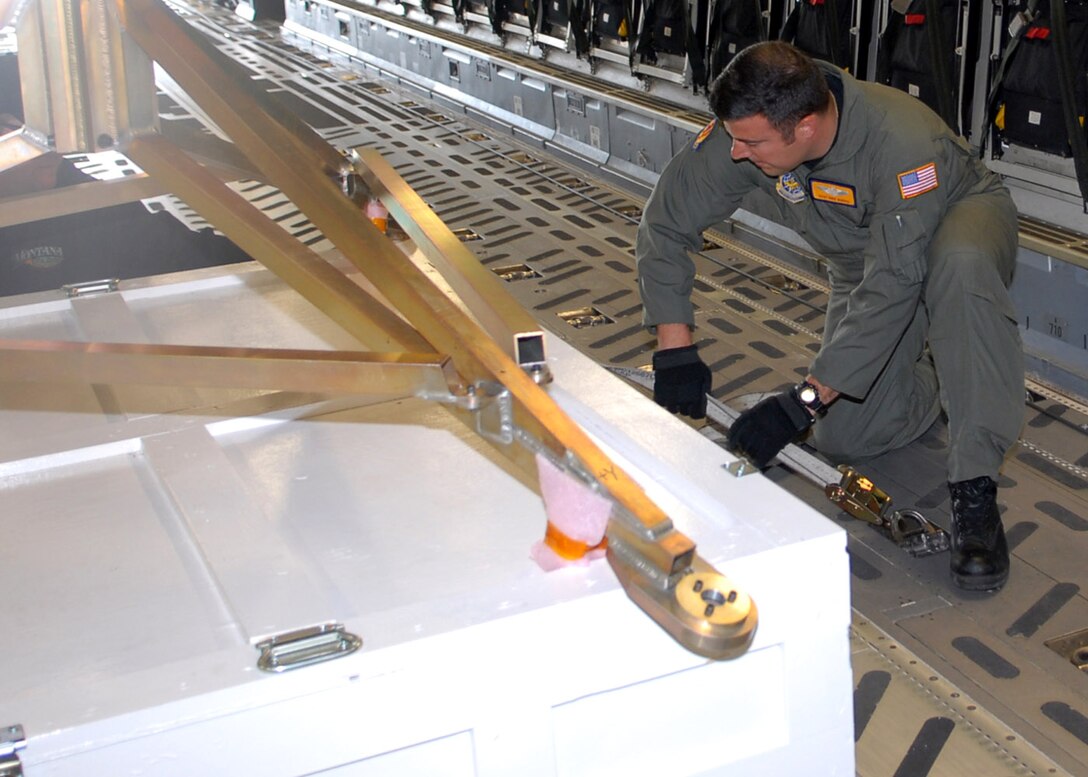 Staff Sgt. Mike Morris secures support equipment for NASA's Phoenix Mars Lander in a C-17 Globemaster III May 7 at Buckley Air Force Base, Colo. The lander, which was built at Lockheed Martin Space Systems Company's Waterton Canyon facilities in Littleton, Colo., was loaded on a C-17 for transportation to NASA's Kennedy Space Center in Florida for final test and launch preparations. The Phoenix lander is slated for liftoff aboard a Delta II launch vehicle in early August. Sergeant Morris is a loadmaster with the 16th Airlift Squadron at Charleston Air Force Base, S.C. (U.S. Air Force photo/Airman 1st Class Alex Gochnour)
