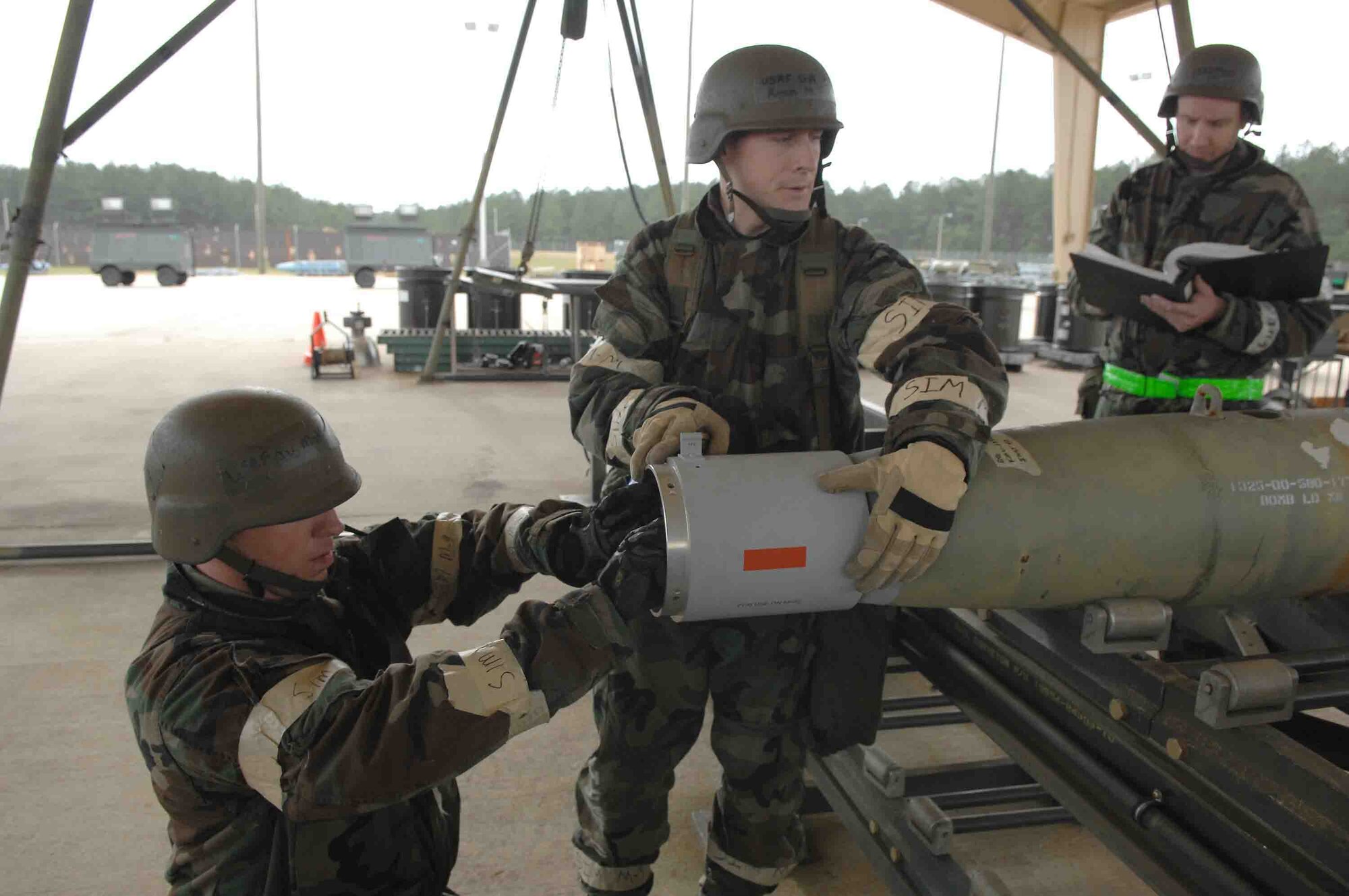 SHAW AIR FORCE BASE, S.C. -- Tech. Sgt. David Allred (right) reads technical operation instructions to his crew members May 9 during the operational readiness exercise. The team was producing GBU-12s to meet flightline frag requirements.  OREs are used as a training tool to help prepare Airmen for pre-deployment and deployment mission requirements. (U.S. Air Force photo/Tech. Sgt. Keri Whitehead)