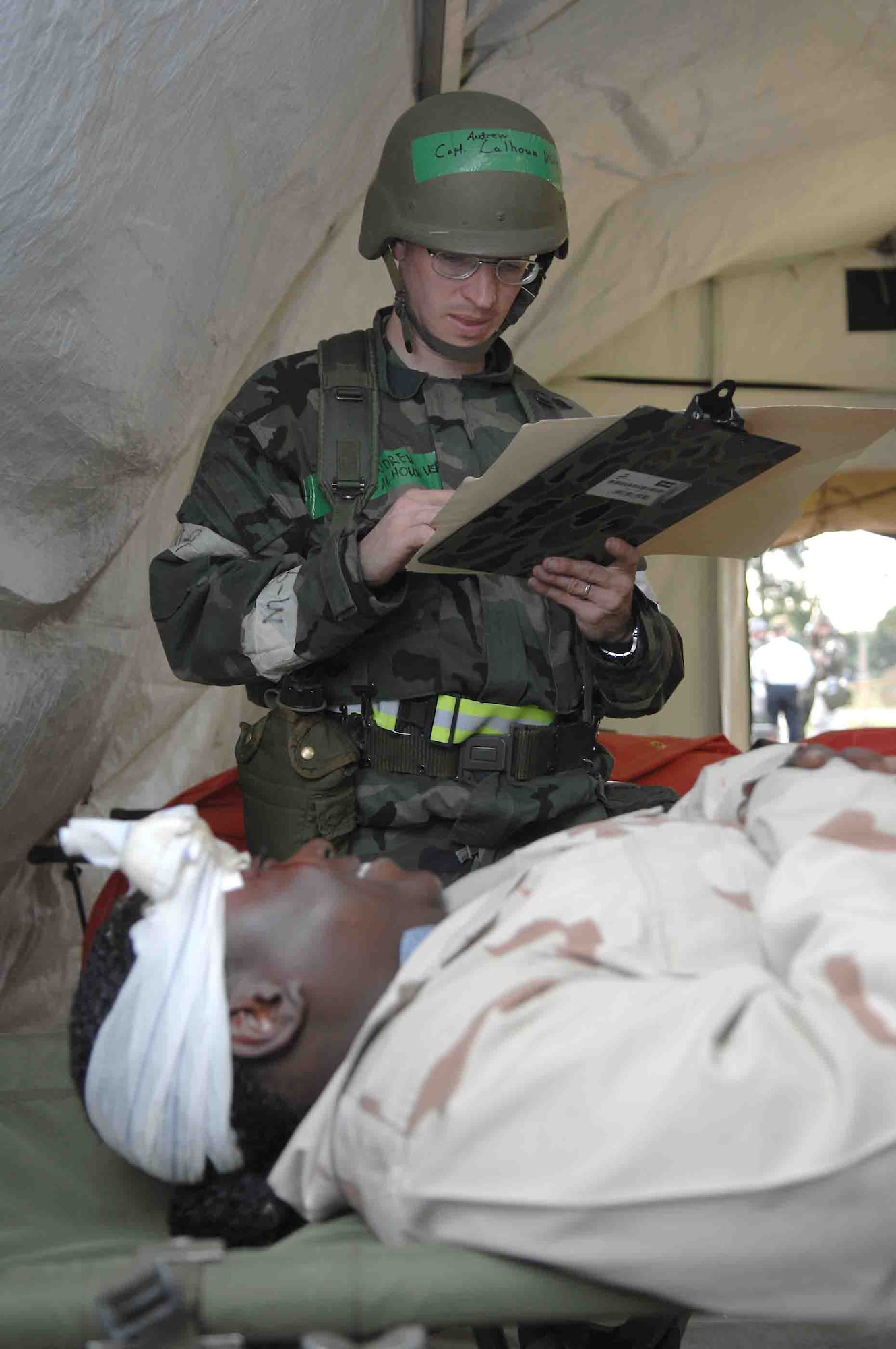 SHAW AIR FORCE BASE, S.C. -- Capt. Andrew Calhoun, 20th Areomedical-Dental Squadron, examines Airman 1st Class Sheena Williams, 20th ADOS, for a simulated head wound May 8 while participating in an operational readiness exercise. OREs are used as a training tool to help prepare Airmen for pre-deployment and deployment mission requirements. (U.S. Air Force photo/Airman 1st Class Matthew Davis)