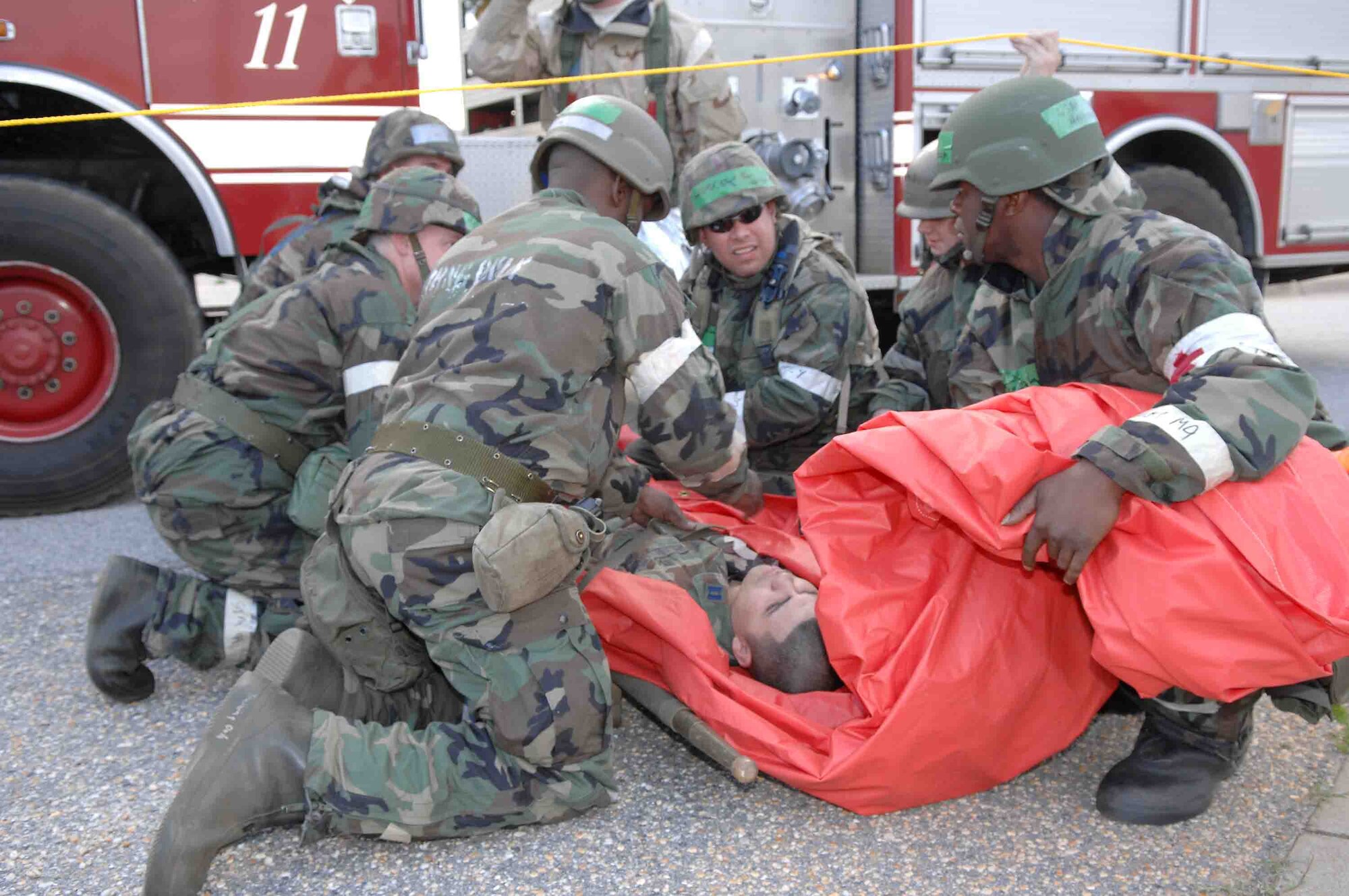 SHAW AIR FORCE BASE, S.C. -- Airmen from the 20th Civil Engineer Squadron Fire Department and the 20th Aeromedical-Dental Squadron unload a simulated casualty from a fire truck May 8 while participating in an operational readiness exercise. OREs are used as a training tool to help prepare Airmen for pre-deployment and deployment mission requirements. (U.S. Air Force photo/Airman 1st Class Matthew Davis)