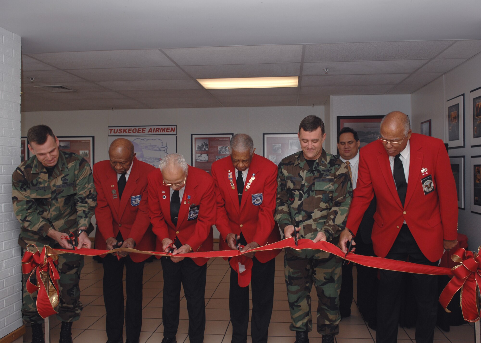 Col. Brian Yolitz, 1st Mission Support Group commander; retired Lt. Col. Francis Horne Sr.; retired Lt. Col. Howard Baugh; retired Chief Master Sgt. Grant Williams Sr., Tuskegee Airmen; Brig. Gen. Burt Field, former 1st Fighter Wing commander and retired Lt. Col. Howard Manly, Tuskegee Airman, cut the ribbon for the opening of the permanent display of Tuskegee Airmen memorabilia in the Langley Main Exchange next to the food court April 25.