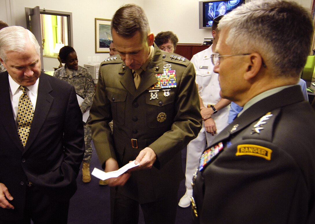 Defense Secretary Robert Gates, Chairman of the Joint Chiefs of Staff Gen Peter Pace and Army Chief of Staff Gen. George Casey talk while waiting for President George W. Bush at the Pentagon, May 10, 2007.