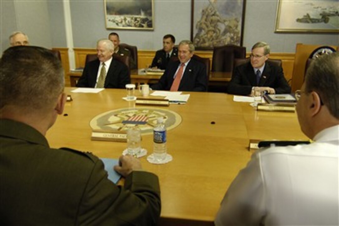 President George W. Bush, center, seated between Defense Secretary Robert Gates, left, and National Security Advisor Stephen Hadley, attends a meeting with senior defense leaders at the Pentagon, May 10, 2007. 