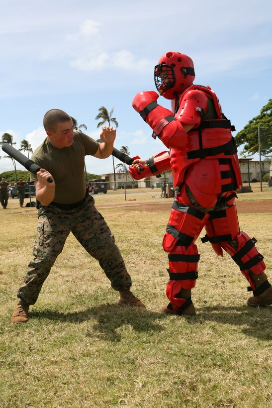 Cpl. Barry Walton, K-9 unit, is dressed up in a "Red Man" suit at station four of the oc spay course. Sailors and Marines from various units around the base participated in the training.