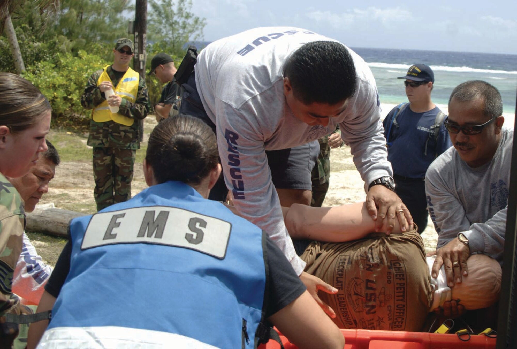 Mark Terlage, secures the victim’s neck, as a joint rescue team moves the victim onto a backboard.  The Air Force, Army, Navy and Coast Guard performed a joint resuce April 26. 