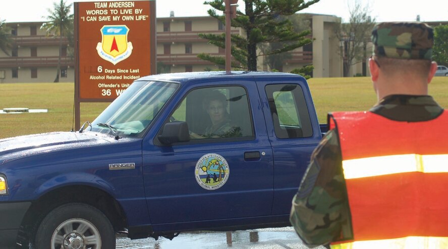 Master Sgt. Mark Sobus, from the 36th Wing Safety Office, inspects vehicles as they approach the wing headquarters to see if the occupants are wearing their seatbelts.  Four safety representatives conducted a random seatbelt inspection Tuesday.  During the inspection, eight out of 584 people counted were not wearing seatbelts.  