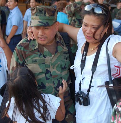A Sailor greets his family after returning to Andersen following a six-month deployment aboard the USS Essex.  Thirty two Sailors were deployed with Detachment Six on the amphibious assault ship attached to the 31st Marine Expeditionary Unit.  