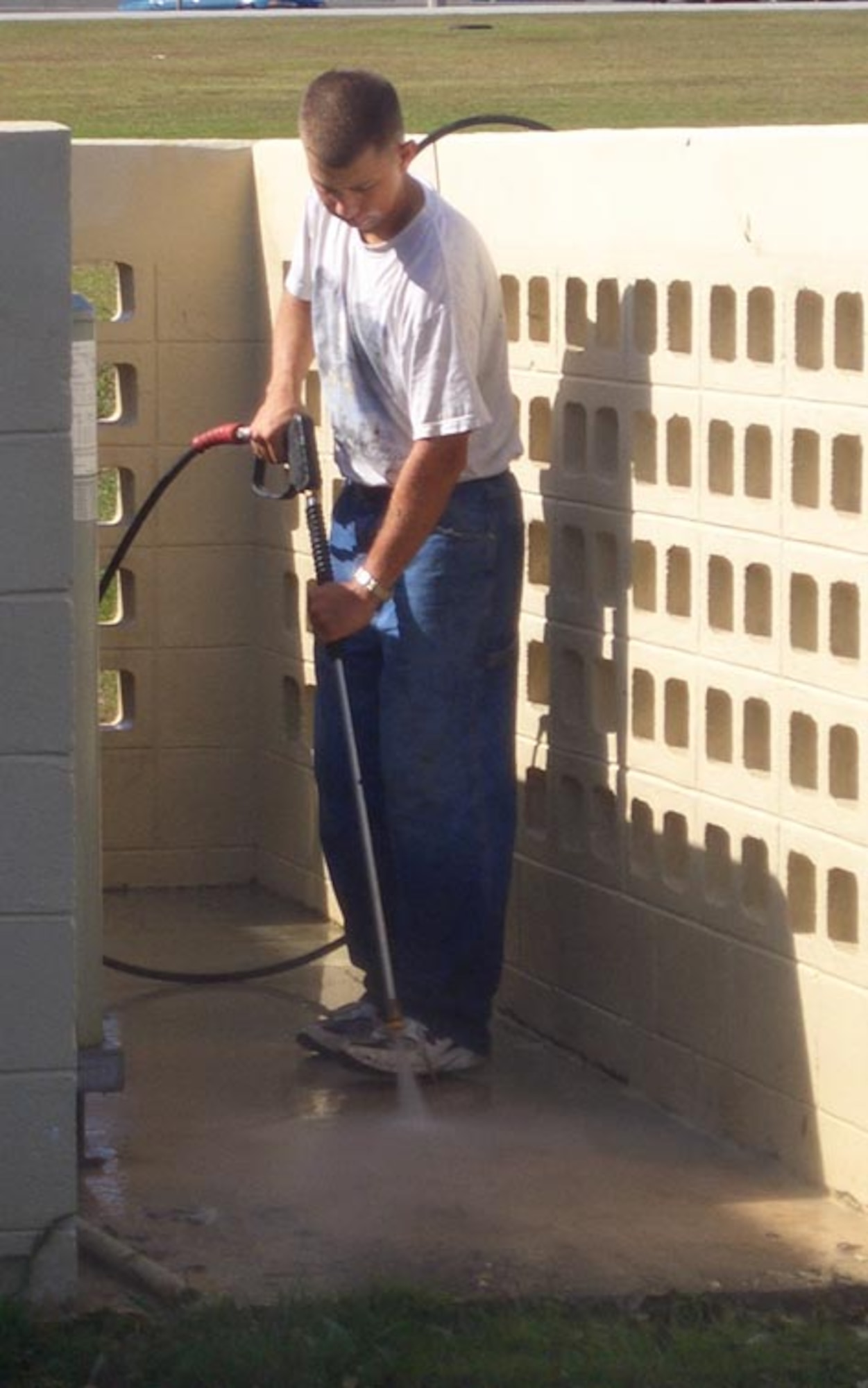 Airman 1st Class John Loker, 36th Logistics Readiness Squadron, volunteers after class to power wash the FTAC building. (Courtesy photo)