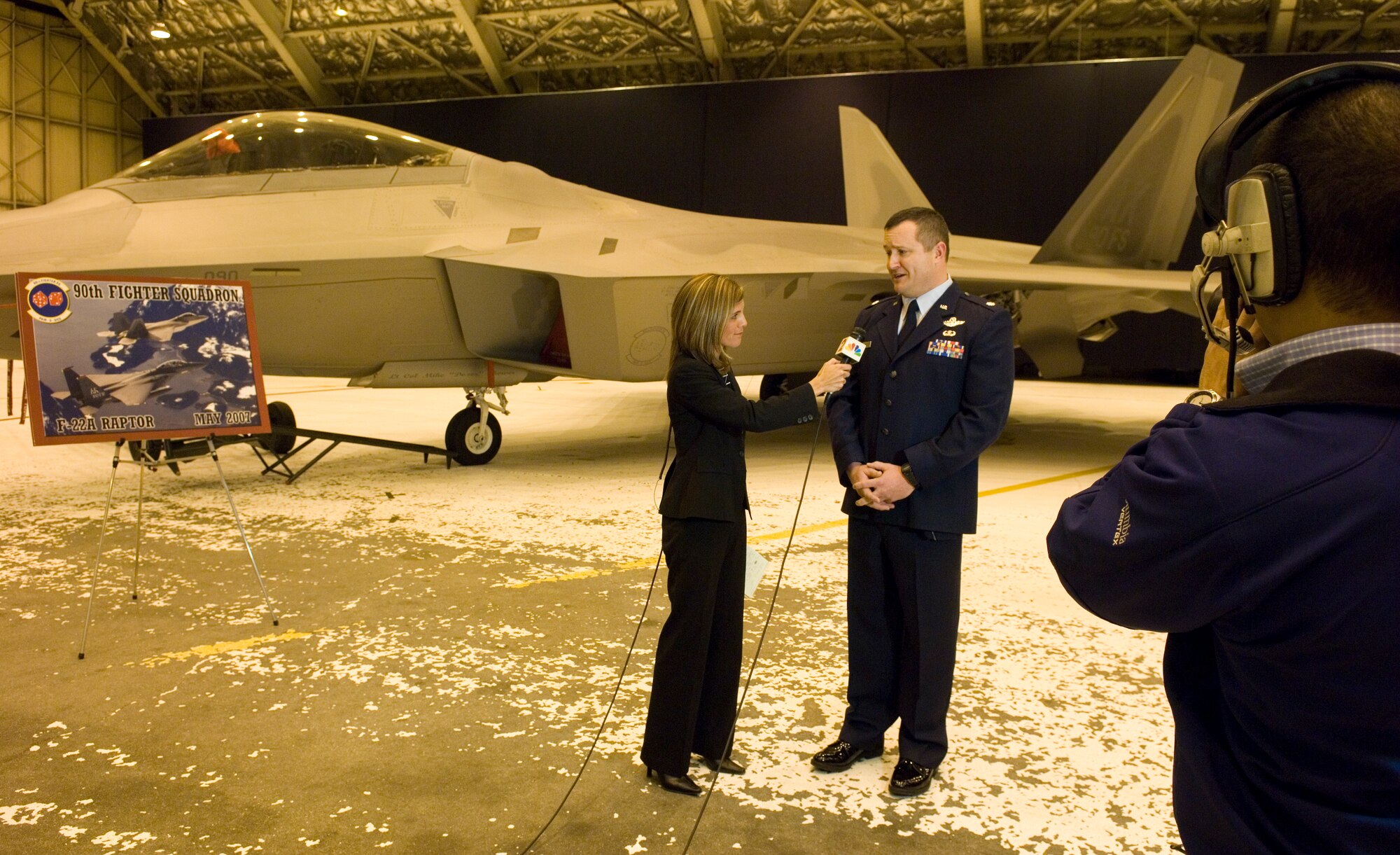ELMENDORF AIR FORCE BASE, Alaska -- Megan Baldino, a reporter from the NBC affiliate in Anchorage, interviews Lt. Col. Michael Shower after he accepted command of the 90th Fighter Squadron during a ceremony here May 10. The historic change of command the squadron's official conversion from the F-15E Strike Eagle to the F-22A Raptor. The 90th FS is the second operational F-22A Raptor squadron and the first for the Pacific Air Forces Command. The squadron will receive its initial wave of Raptors Aug. 8. (U.S. Air Force photo by Senior Airman Garrett Hothan)