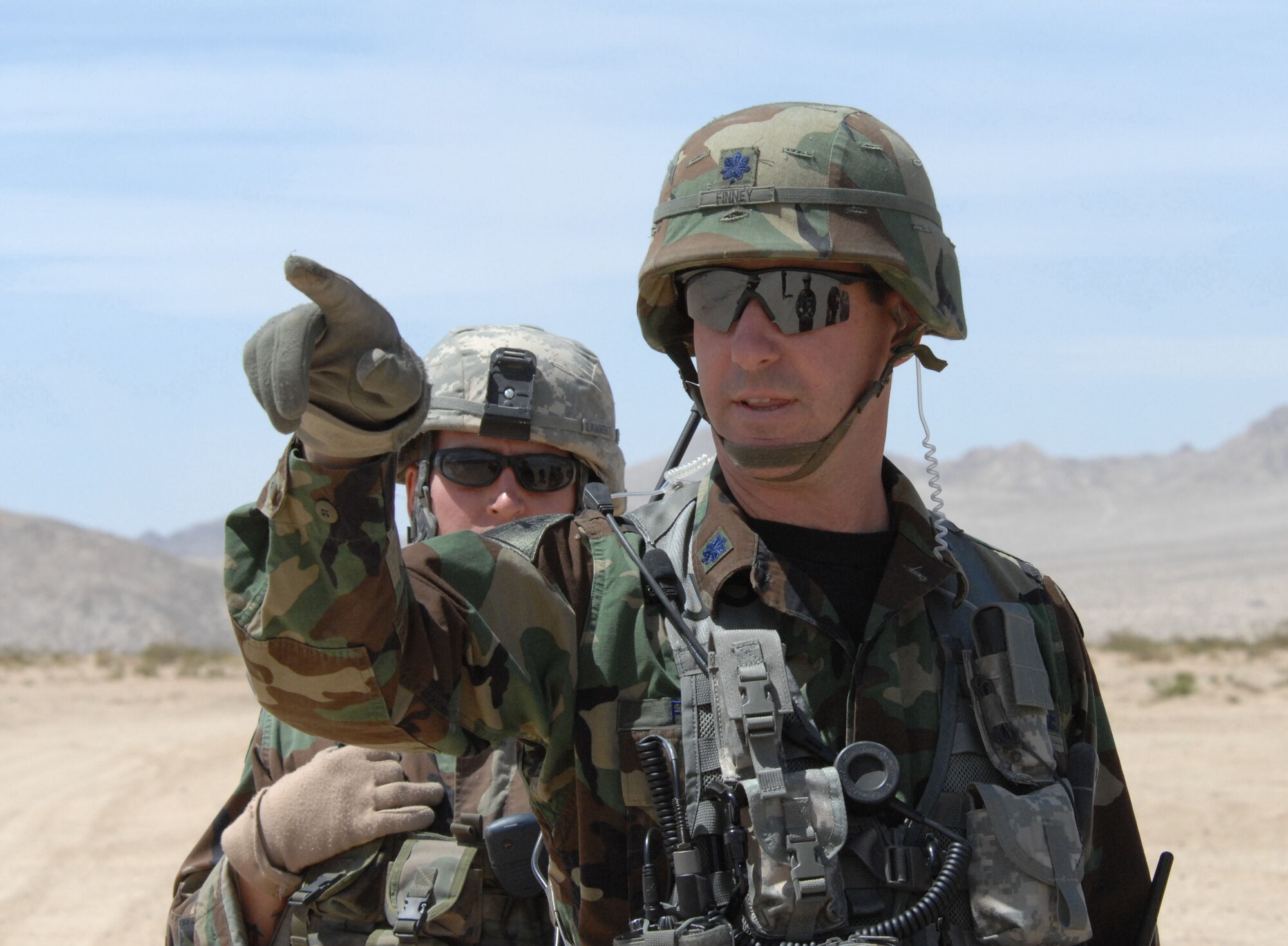 Lt. Col. Michael Finney, 12th Combat Training Squadron commander, along with Staff Sgt. Jeff Lawrence, 12th CTS Joint Terminal Attack Controller, point out some areas on the range at Fort Irwin, Calif., where Soldiers and Airmen are trained in a realistic environment.  Colonel Finney is the senior Air Force member assigned to Fort Irwin and advises the Army commander on how to effectively incorporate the Air Force into the National Training Center mission. (U.S. Air Force photo by Staff Sgt. Jeremy Smith)
photo by Staff Sgt Jeremy Smith