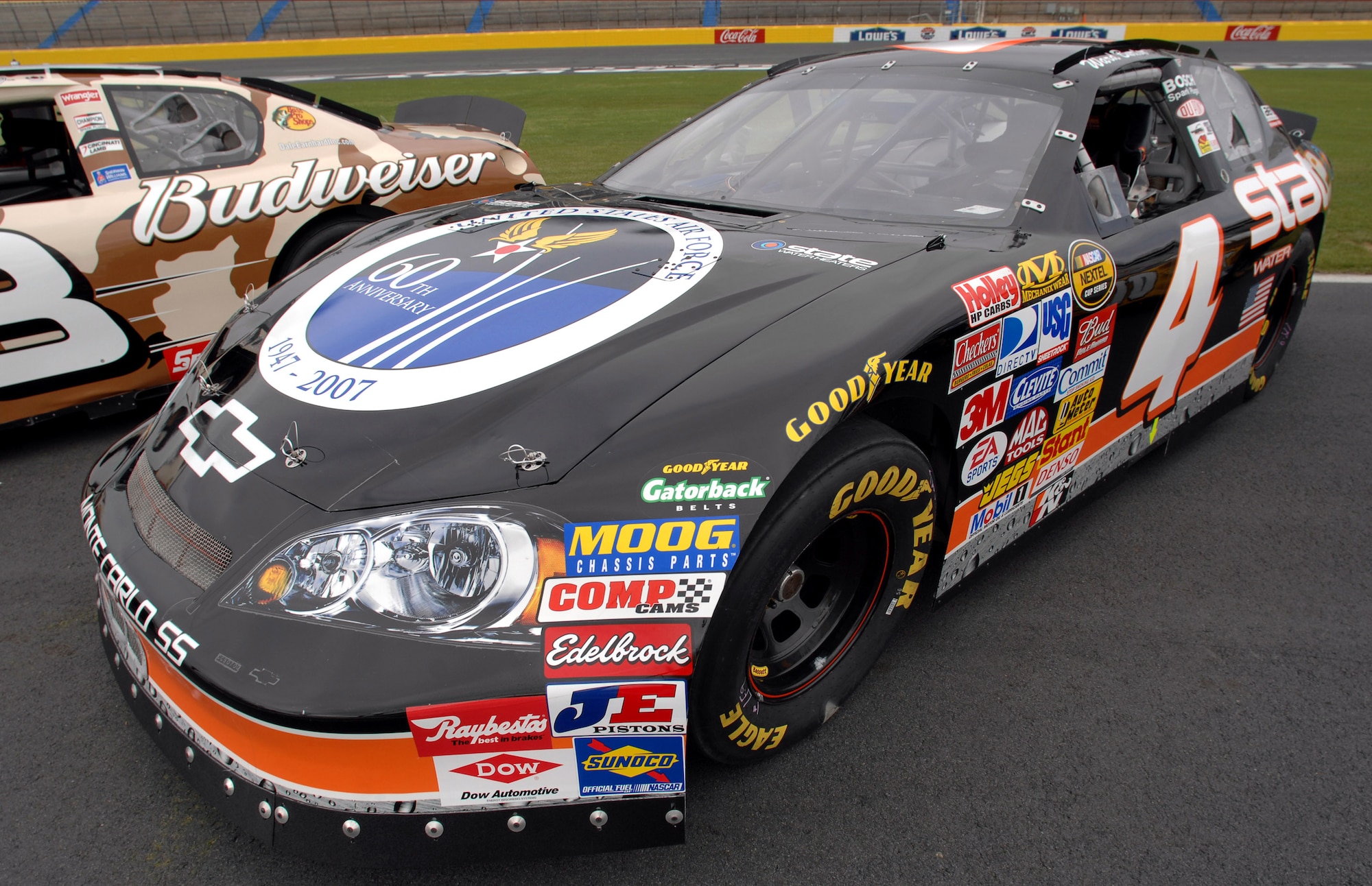 The U.S. Air Force 60th anniversary logo is unveiled on the hood of NASCAR driver Ward Burton's State Water Heaters car during an unveiling ceremony May 8 at Lowe's Motor Speedway in Charlotte, N.C. The unveiling was in recognition of "American Heroes Memorial Day Salute to the Armed Forces". (Department of Defense photo/William D. Moss)
