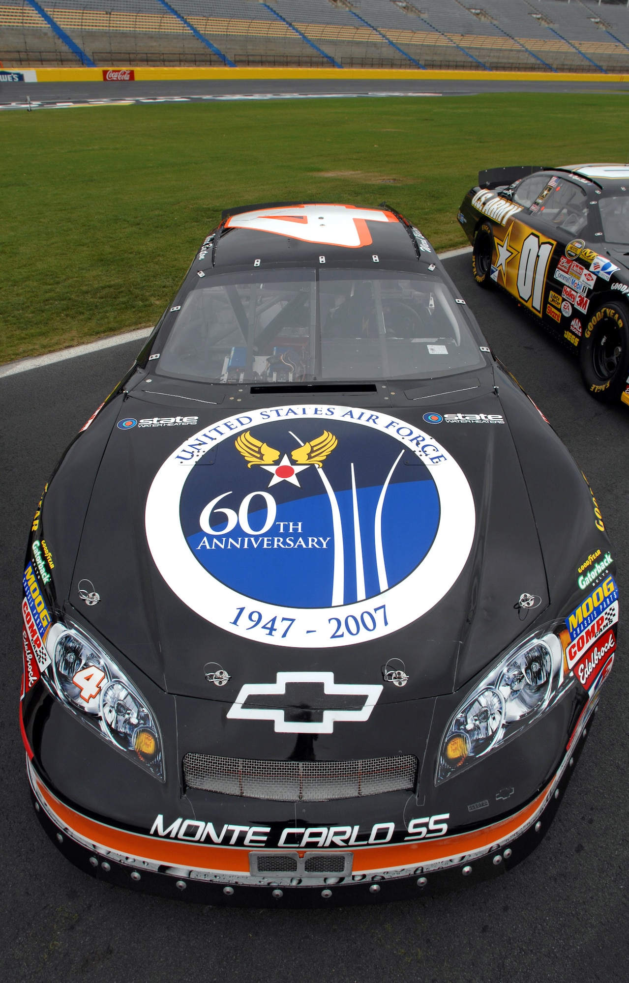 The U.S. Air Force 60th anniversary logo is unveiled on the hood of NASCAR driver Ward Burton's State Water Heaters car during an unveiling ceremony May 8 at Lowe's Motor Speedway in Charlotte, N.C. The unveiling was in recognition of "American Heroes Memorial Day Salute to the Armed Forces". (Department of Defense photo/William D. Moss)