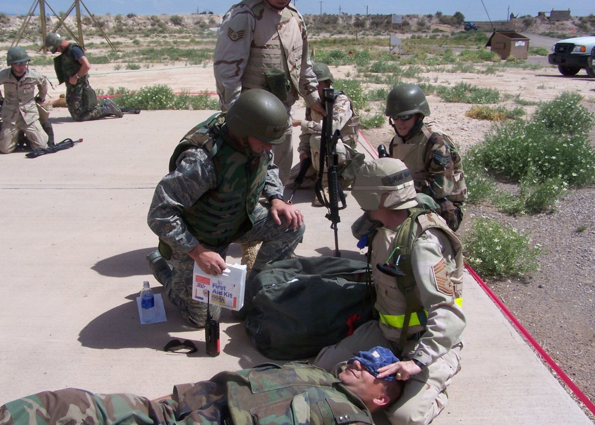 Brig. Gen. David Goldfein, 49th Fighter Wing commander, and Chief Master Sgt. Marjorie McNichols, 49 FW command chief, perform self aid and buddy care after a simulated attack during the Phase II exercise at Holloman. (U.S. Air Force photo courtesy of the 49th Civil Engineer Squadron)