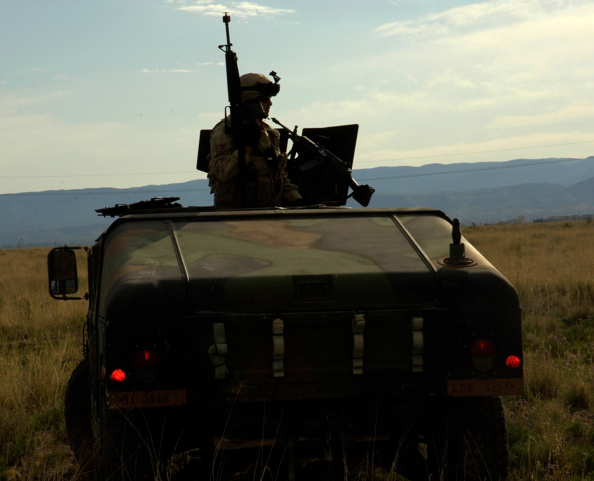 An Airman from the 49th Civil Engineer Squadron surveys out a humvee during a convoy for the Phase II exercise at Holloman. The 49 CES trained with Army for this convoy.  (U.S. Air Force photo by Airman 1st Class Michael Means)