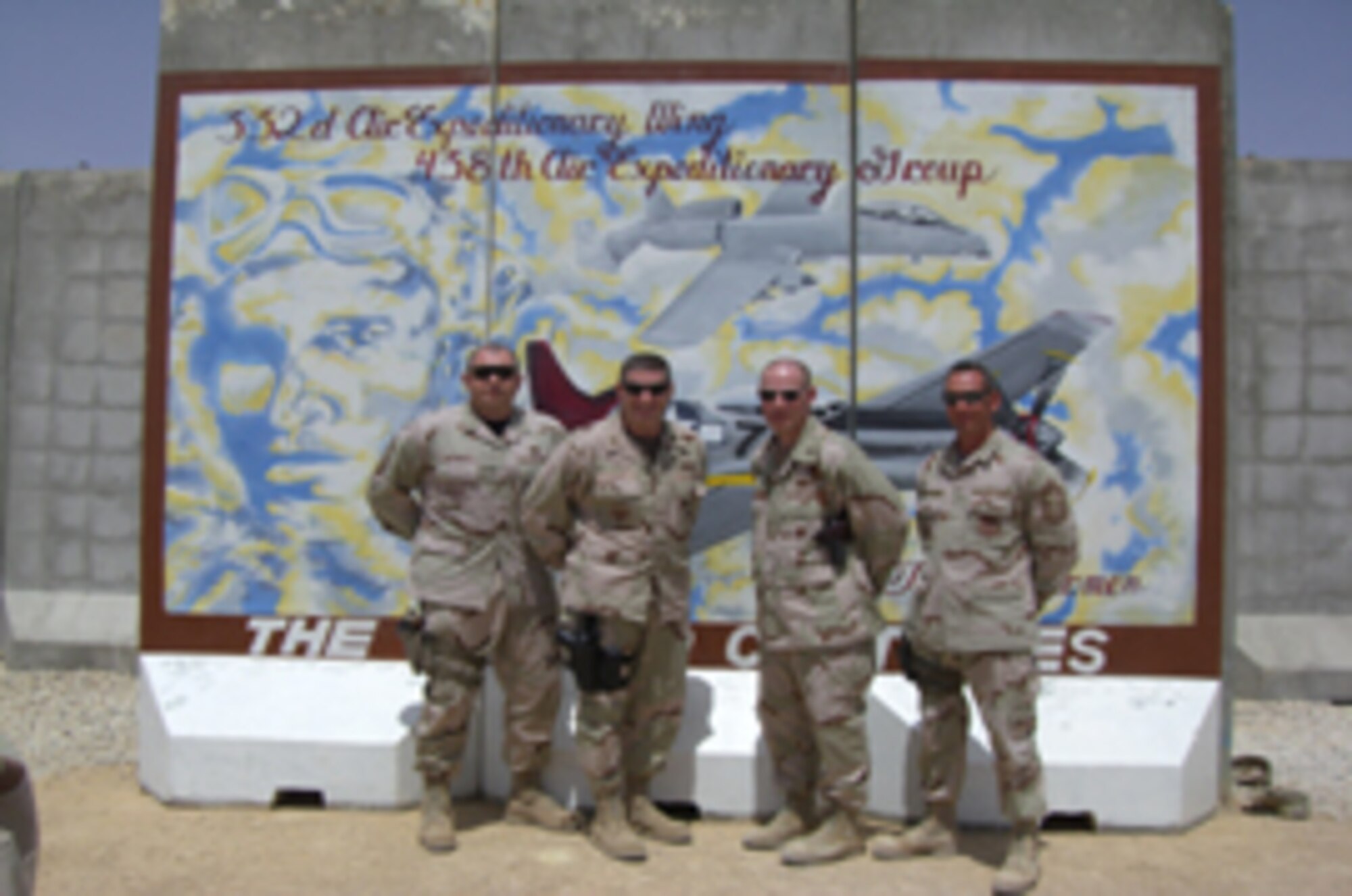 LEFT TO RIGHT:  Command ChiefMaster Sgt. Scott Dearduff, Brig. Gen. Robin Rand, 332nd Air Expeditionary Wing commander, Col. Patrick Malickowski, 438th
Air Expedtionary Group commander, and Chief Master Sgt. Bryce Maxson, 438th AEG group superintendent deployed from Luke, pose in front of the 438th AEG’s
recently painted legacy mural at Al Asad. (Courtesy photo)