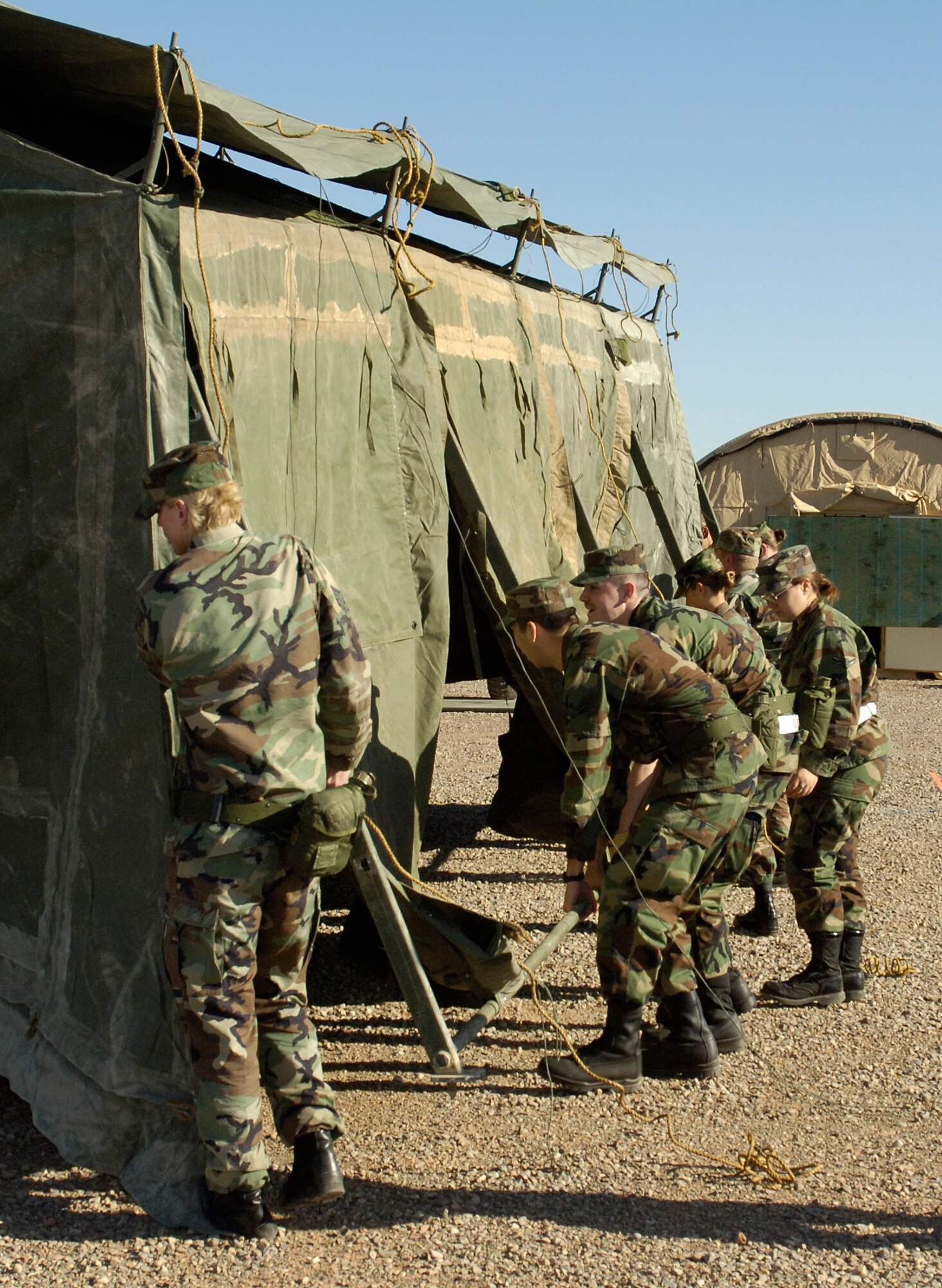 Airmen help set up a tent for tent city where more than 250 Airmen lived during the Phase II exercise at Holloman. (U.S. Air Force photo by Airman 1st Class Michael Means)