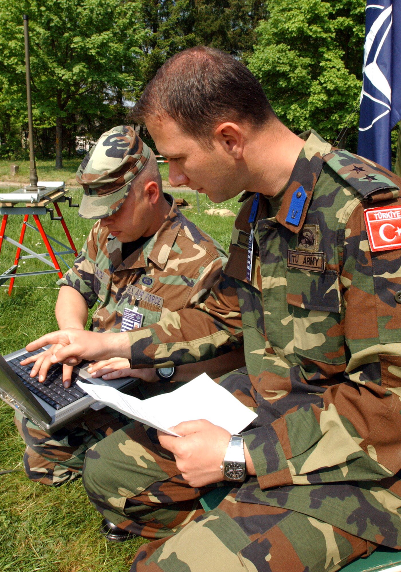 Airman 1st Class Adam Wallace and Turkish 1st Lt. Burak Aksu input data into a laptop computer during exercise Combined Endeavor 2007 in Lager Aulenbach, Baumholder, Germany.  The exercise, a U.S. European Command-sponsored exercise, brings the U.S. and other nations together, especially those in NATO or Partnership for Peace, to plan and execute interoperability testing of command, control, communications and computer systems in preparation for future combined humanitarian, peacekeeping and disaster relief operations.  (U.S. Air Force photo/Senior Airman Dayton Mitchell)