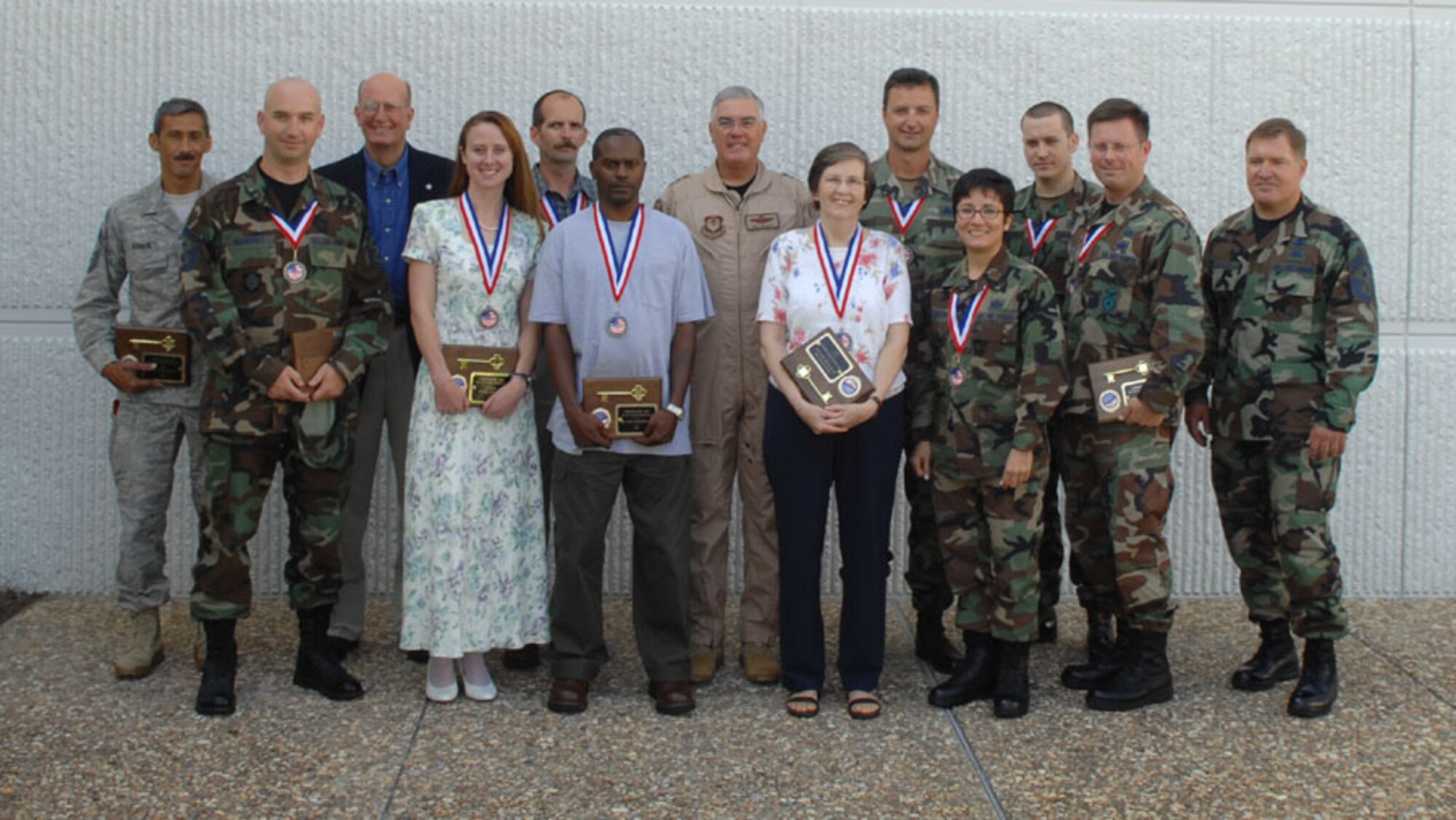 The Air Force Special Operations Command Outstanding Airmen of the Year pose with Lt. Gen. Michael Wooley, AFSOC commander, and Chief Master Sgt. Michael Gilbert, AFSOC command chief, outside of AFSOC headquarters. Several of the AFSOC OAY winners will go on to compete at Air Force level. (U.S. Air Force photo by Seniro Airmen Cynthia Morrow)