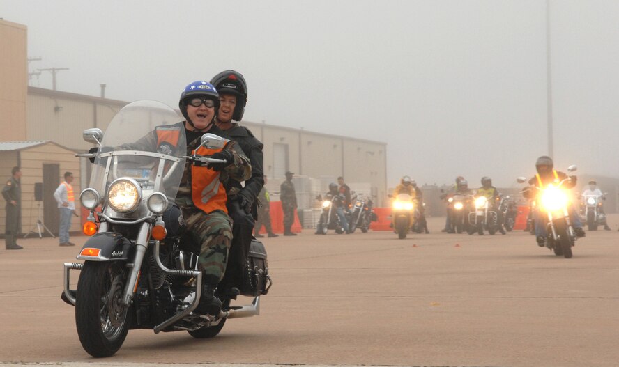 7th Bomb Wing Command Chief Master Sgt. Paul Wheeler and 317th Airlift Group Command Chief Master Sgt. Debra Huntley lead a pack of bikers during the Team Dyess motorcycle rodeo May 11. This is part of a motorcycle safety and training program held every year at Dyess before the 101 Critical Days of Summer (U.S Air Force photo by Staff Sgt. Araceli Alarcon)