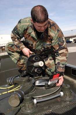 MCCHORD AIR FORCE BASE, Wash. -- Staff Sgt. Joseph Pinkham, 62nd Logistics Readiness Squadron, checks the seal on a manhole on the catwalk of an R-11 fuel truck servicing vehicle. (U.S. Air Force photo/Abner Guzman)