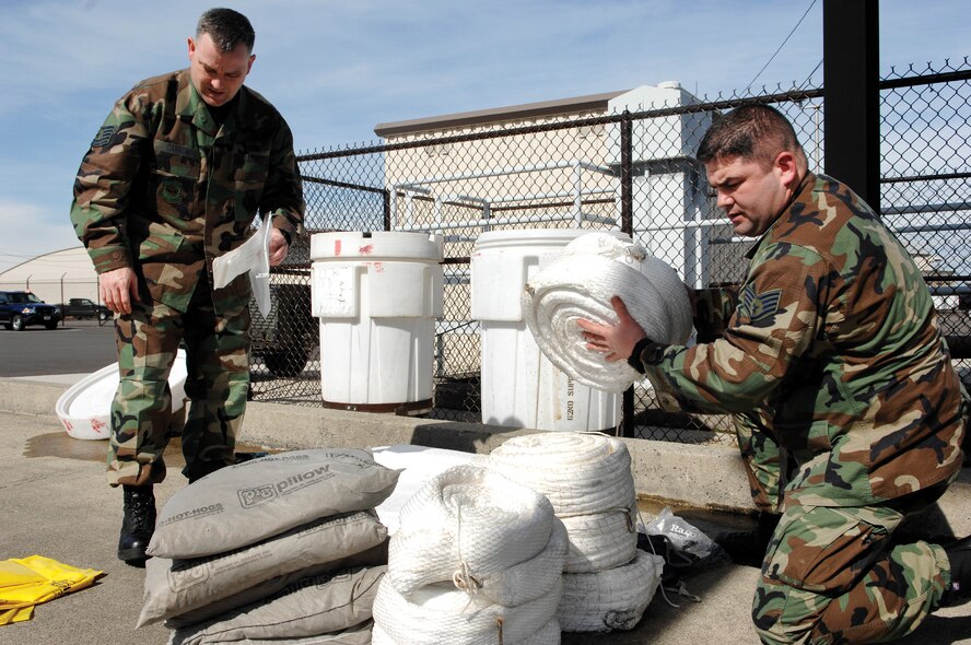 MCCHORD AIR FORCE BASE, Wash. -- Tech. Sgt. Greg Carrow, left, and Staff Sgt. Joseph Pinkham, both from the 62nd Logistics Readiness Squadron inspect a fuel spill response kit to insure Airmen have inventoried and properly stored items needed in the event of an emergency. (U.S. Air Force photo/Abner Guzman)