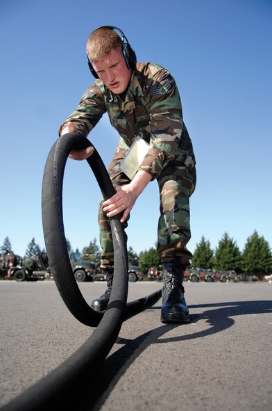 MCCHORD AIR FORCE BASE, Wash. -- Senior Airman Bradley Zink, a 62nd Logistics Readiness Squadron fuel distribution operator, inspects a refueling hose for cuts and leaks during a routine equipment check. (U.S. Air Force photo/Abner Guzman)
