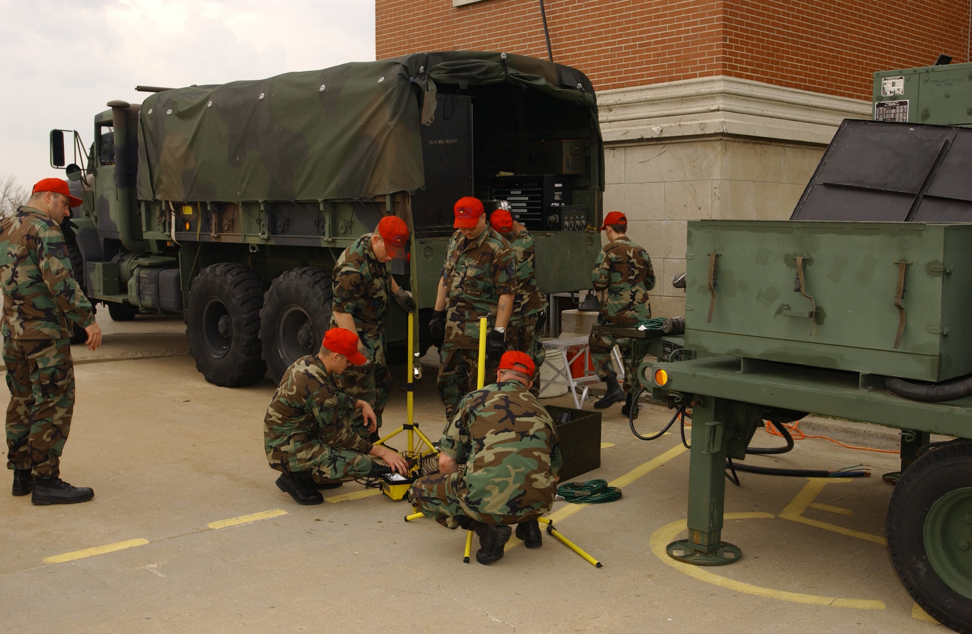 Airmen of the 184th Air Refueling Wing prepare portable lights for night operations May 5 in Greensburg, Kan. Around 500 Army and Air National Guardmembers are in Greensburg removing debris, providing security, generating power, preparing food and performing other disaster relief functions. (U.S. Air Force photo) 
