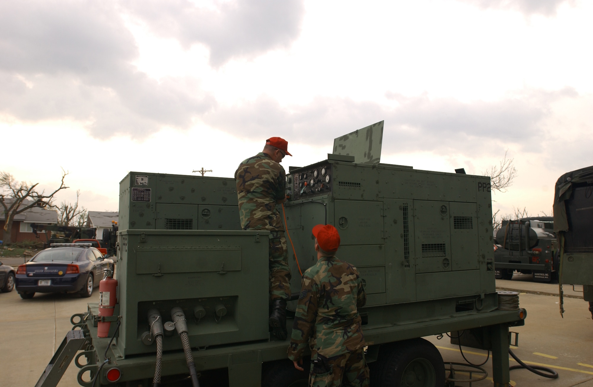 Two Kansas Air Guardsmen from the 184th Air Refueling Wing out of Wichita establish 120kw generator support May 5 for the town of Greensburg, Kan. Around 500 Army and Air National Guardmembers are in Greensburg removing debris, providing security, generating power, preparing food and performing other disaster relief functions. (U.S. Air Force photo) 
               