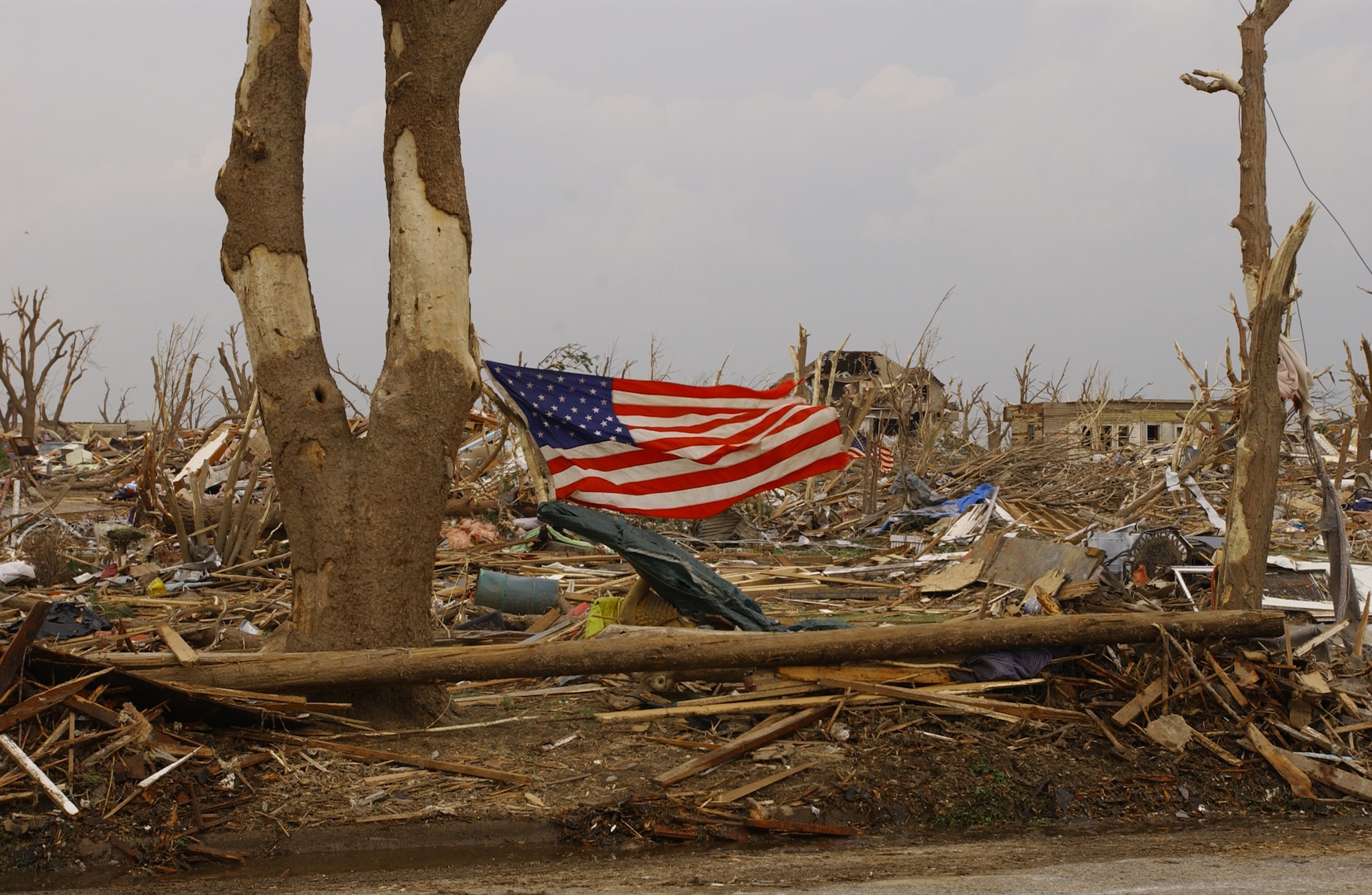 An American flag flies in Greensburg, Kan., after an F5 tornado hit the town May 4. Around 500 Army and Air National Guardmembers are in Greensburg removing debris, providing security, generating power, preparing food and performing other disaster relief functions. (U.S. Air Force photo)                       