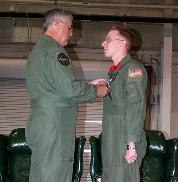 Staff Sgt. Eric "EZ" Ezell, 20th Special Operations Squadron, recieves the Purple Heart Medal May 7 from Lt. Gen. Michael Wooley, Air Froce Special Operations Command commander. Sergeant Ezell sustained injuries to his right eye from a bullet Dec. 28, 2006, during a combat operation in support of Operation Iraqi Freedom. (U.S. Air Force Photo by Jamie Haig)