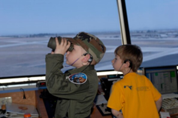 Christian “Champ” Simmons, 7, and brother Jake “The Snake,” 6, watch from the control tower an F-16 launch during part of the Pilot for a Day program. Champ visited the 62nd Fighter Squadron and became the youngest member of the
56th Fighter Wing May 4. (Staff Sgt David Miller)