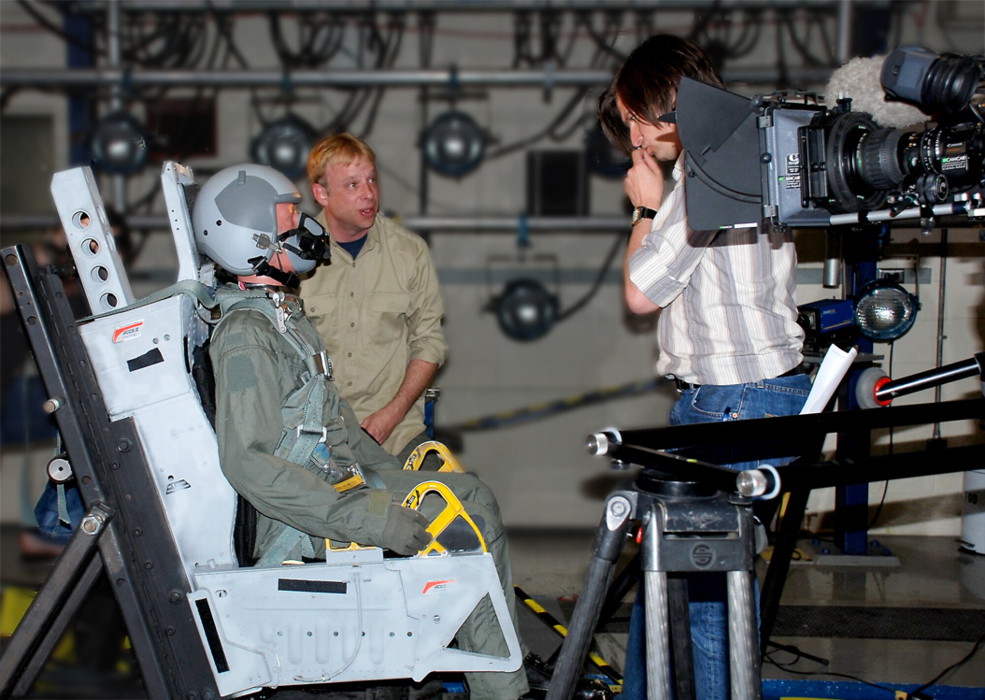 Test technician Brian Grattan (left) of General Dynamics Advanced Information Systems, discusses the next film sequence with producer Daniel Muenter. Muenter's independent German film crew is producing a documentary of early and contemporary high-altitude research conducted at the Air Force Research Laboratory's Human Effectiveness Directorate. (Photo by John Schutte AFRL/HE)