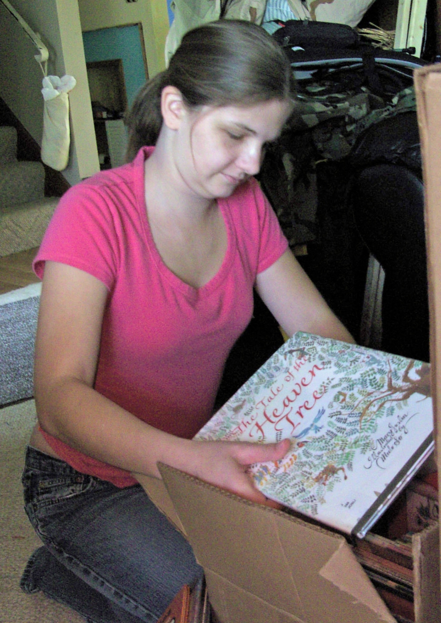 Courtney Hromada of Englewood, Ohio, looks over one of a dozen or more boxes of items to be sent to military members hospitalized in Kuwait. A high school senior, she organized the project not only to help the military, but also as her community service effort to earn the Girl Scout Gold Award. (U.S. Air Force/Rodney Hromada)