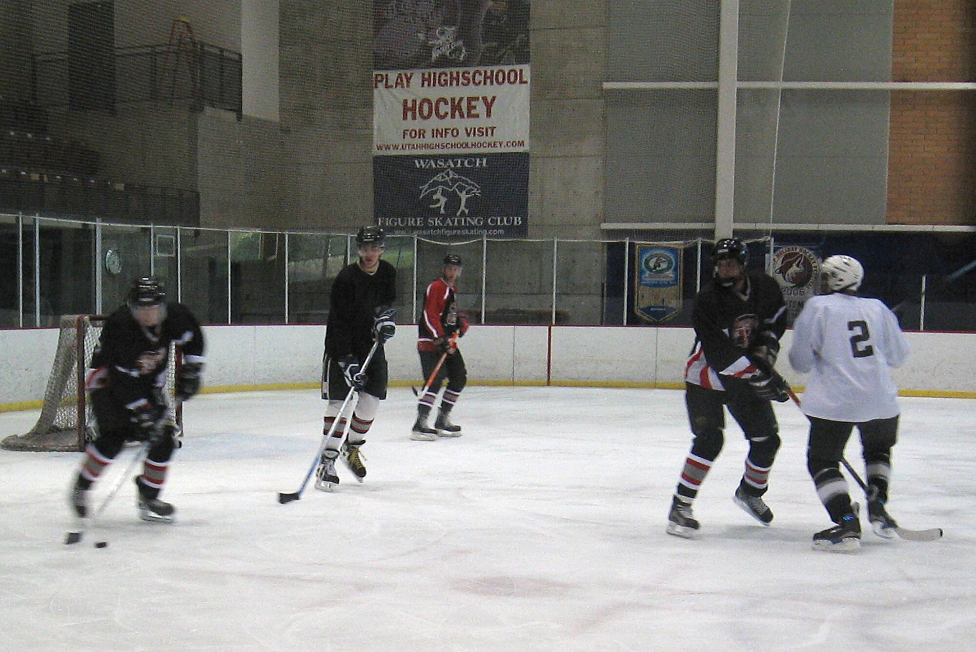 Members of the Hill Air Force Base ice hockey team (dark jerseys) attempt to clear the puck from their defensive zone during Sunday’s game at the Weber County Ice Sheet, Ogden, Utah. The Hill AFB team competes in a community league against other teams with varying talent levels. The talent level of the competition on Sunday was extremely high as the Hill AFB team lost the game 4-12. The team is waiting to find out when its first playoff game will be held. As of press time for the Hilltop Times, the team expects to play Sunday, but the time is uncertain. Keep reading the Hilltop Times for ice hockey coverage as Hill AFB makes a run in the playoffs. (Photo by Margarita Smith)