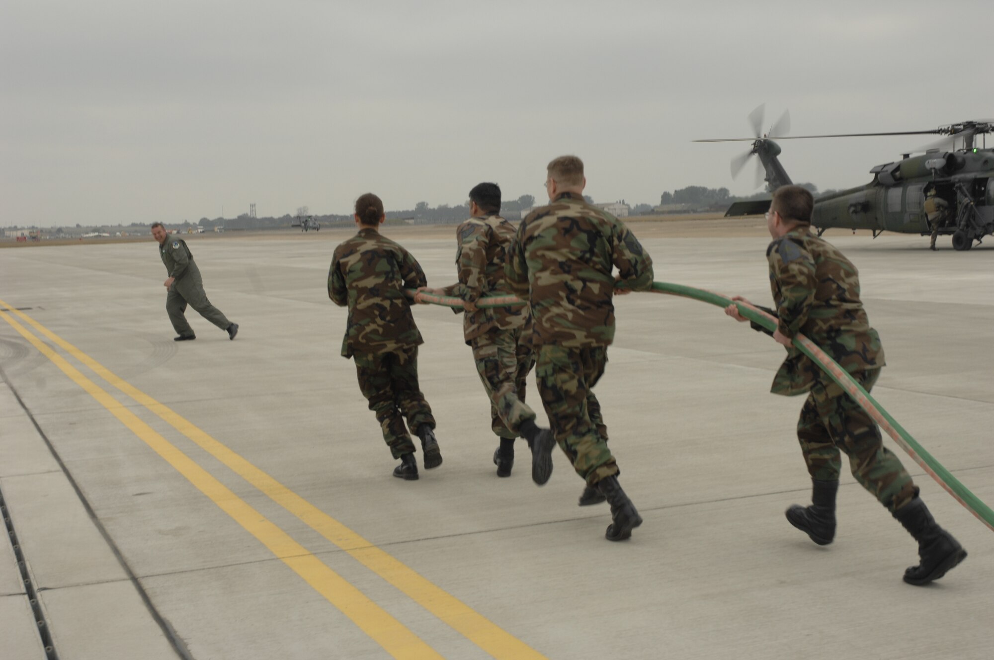 Members of the Liberty 56 scramble to hose down Command Chief Master Sgt. Jerry K. Sutton after his fini flight May 3. Chief Sutton retires May 18 after 23 years of Air Force service and a year and a half as the top enlisted Liberty Airman. During his tenure at RAF Lakenheath Chief Sutton provided senior enlisted leadership for four groups and 22 squadrons consisting of over 5,000 enlisted personnel.  (U.S. Air Force photo by Airman 1st Class Jessica Snow)